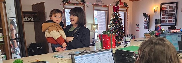 Young Patient And Mom Checking In